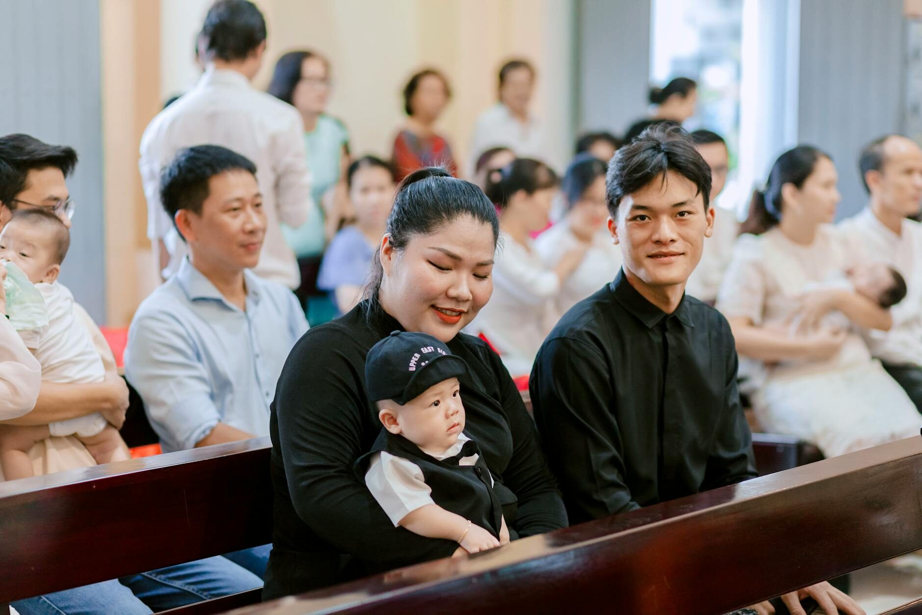 father and mother sitting with baby at church